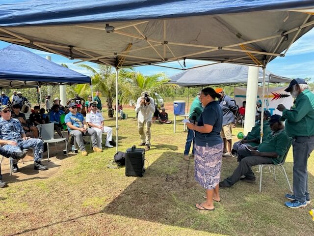 Lady talking in front of a crowd Port Melville 