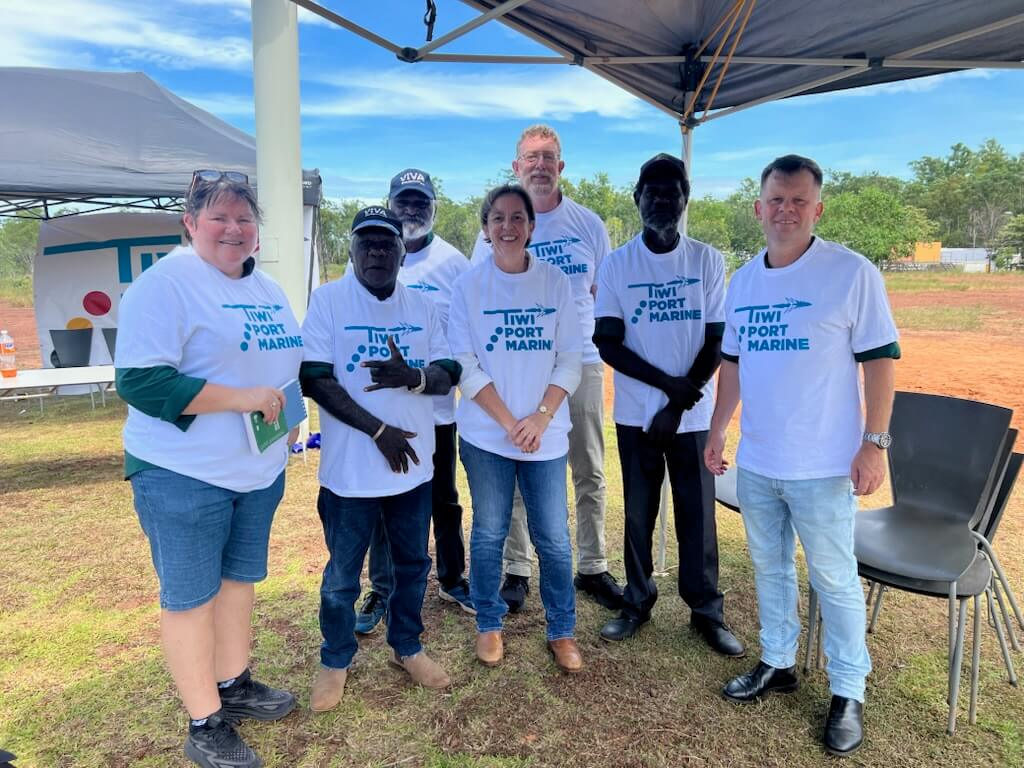 Group of people smiling, wearing "Tiwi Port Marine" shirts