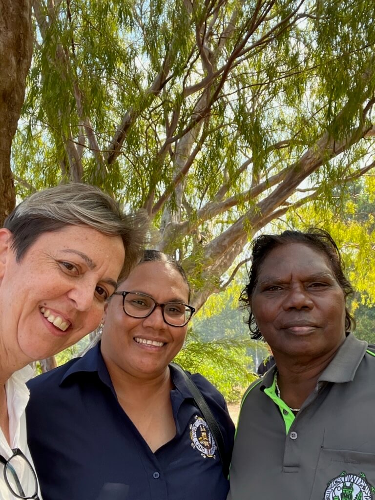 Three people smiling for camera