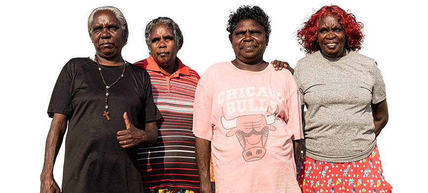 Group of indigenous ladies smiling and looking at the camera.